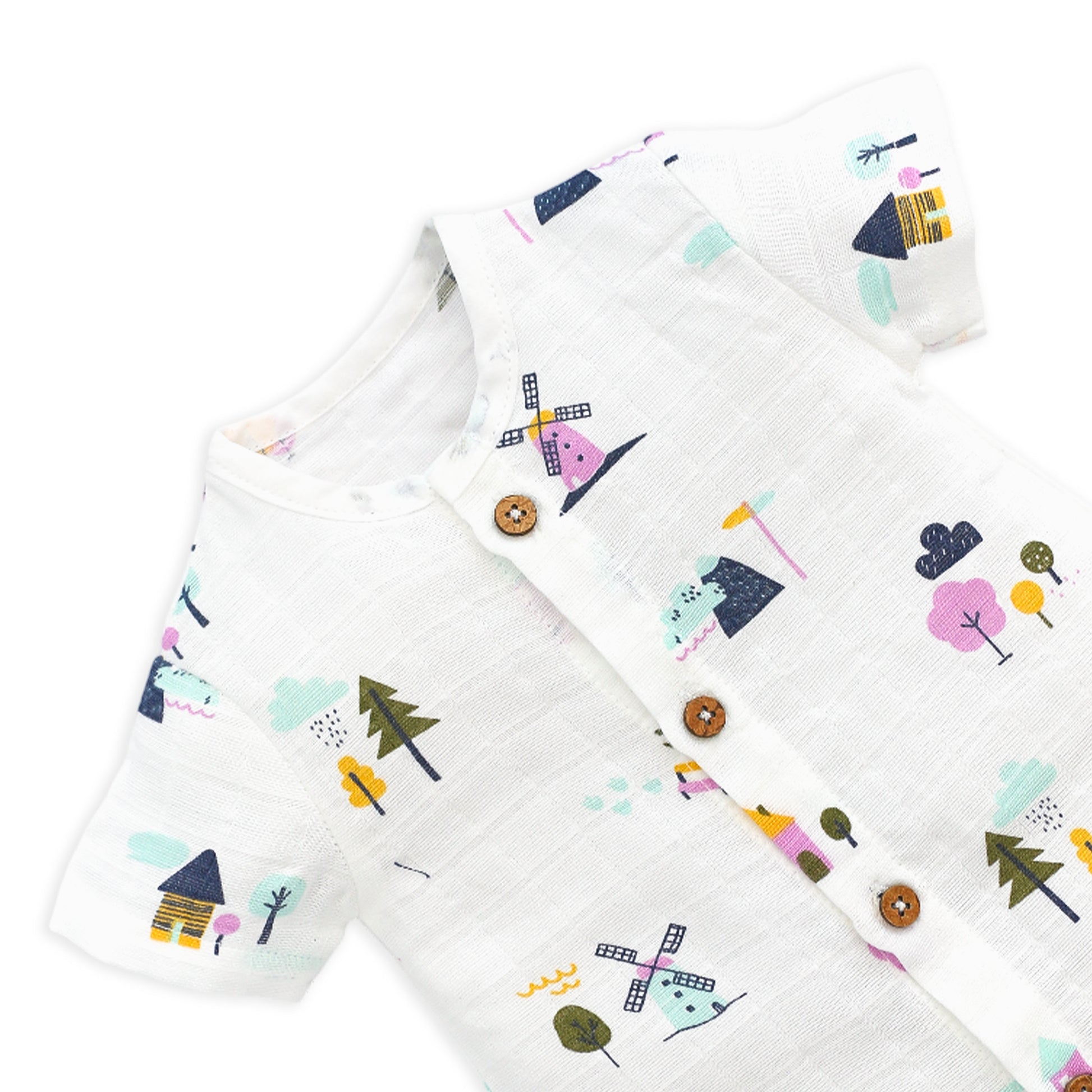 Close-up of premium muslin fabric texture and wooden button details on baby romper