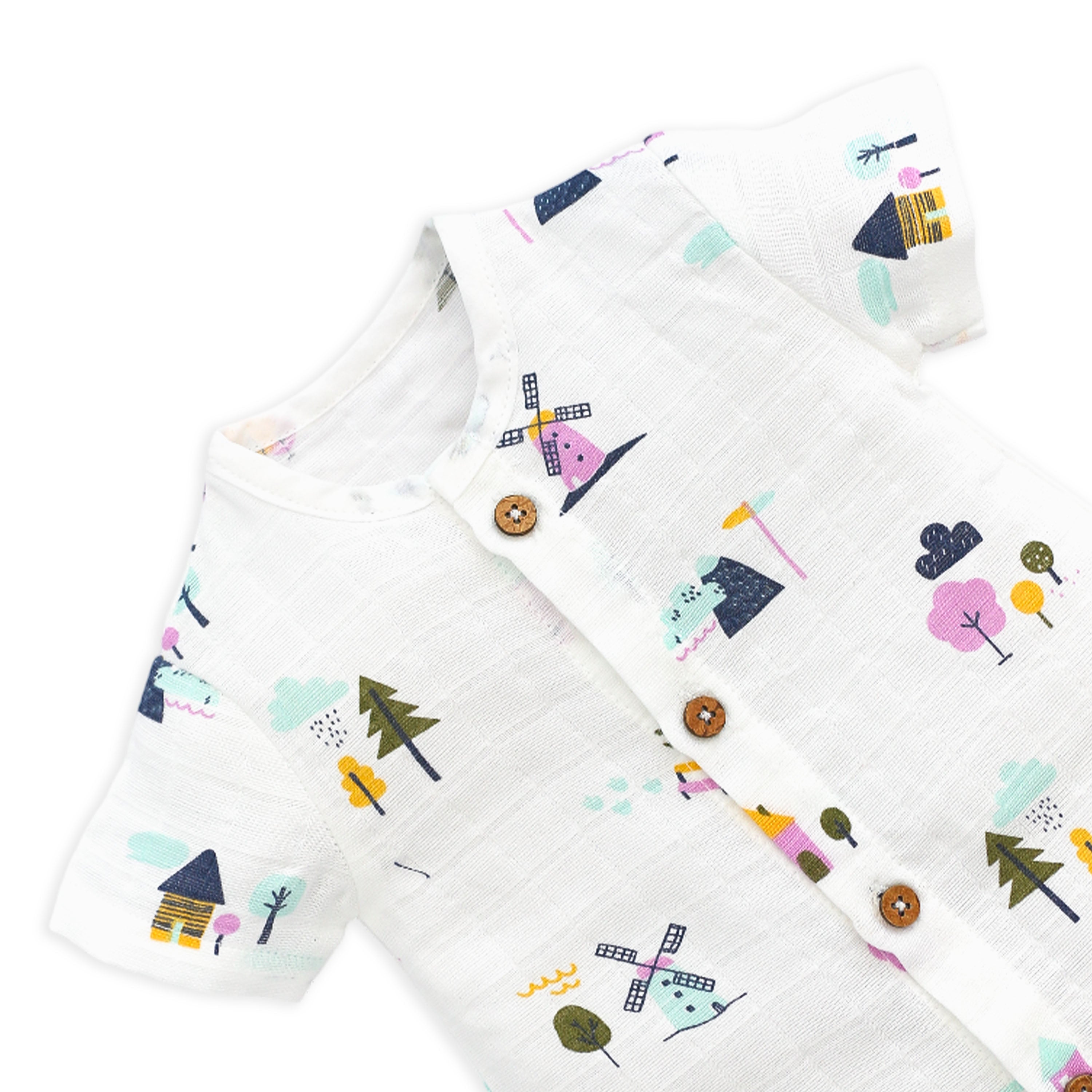 Close-up of premium muslin fabric texture and wooden button details on baby romper