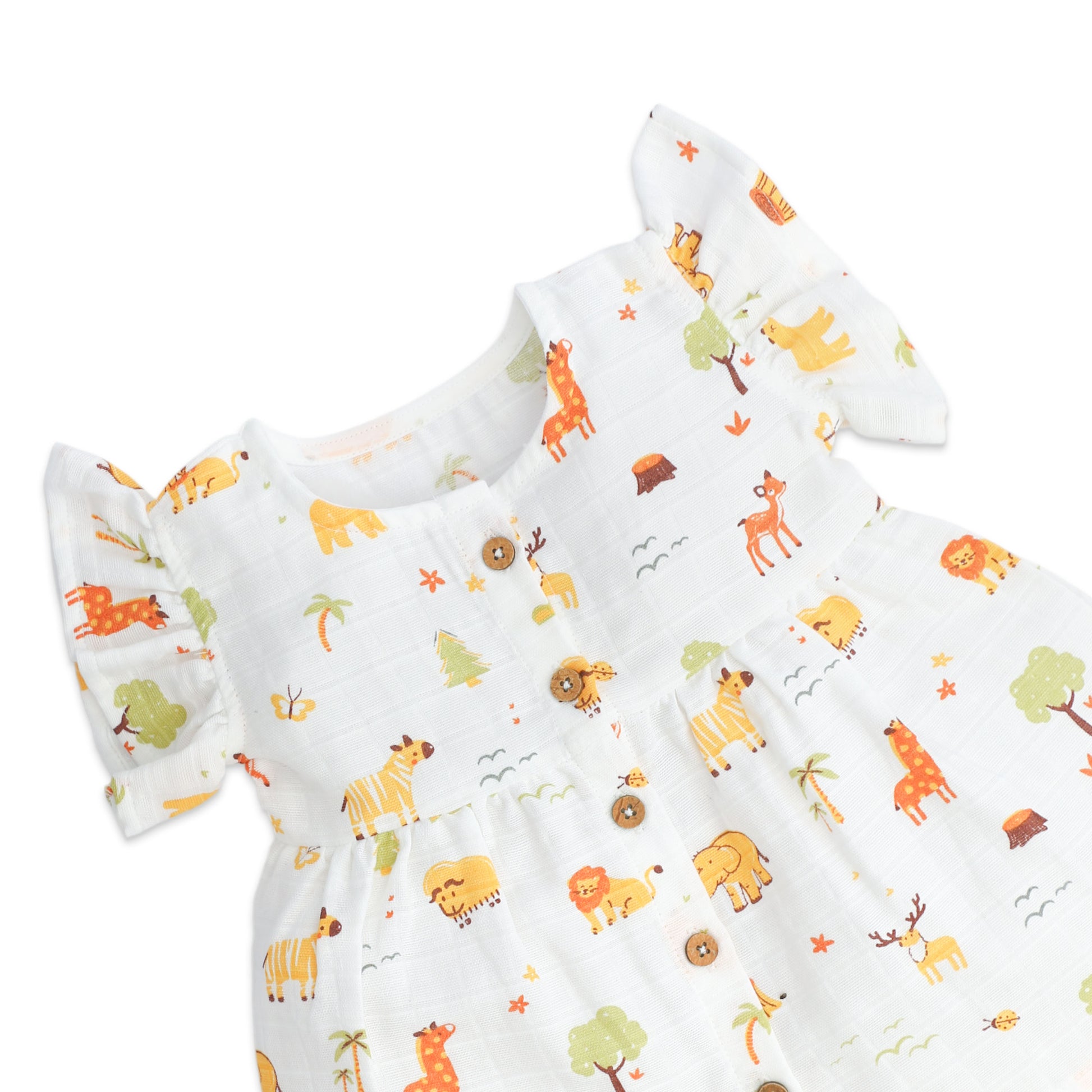 Baby girls frock with animal pattern on a white muslin fabric 