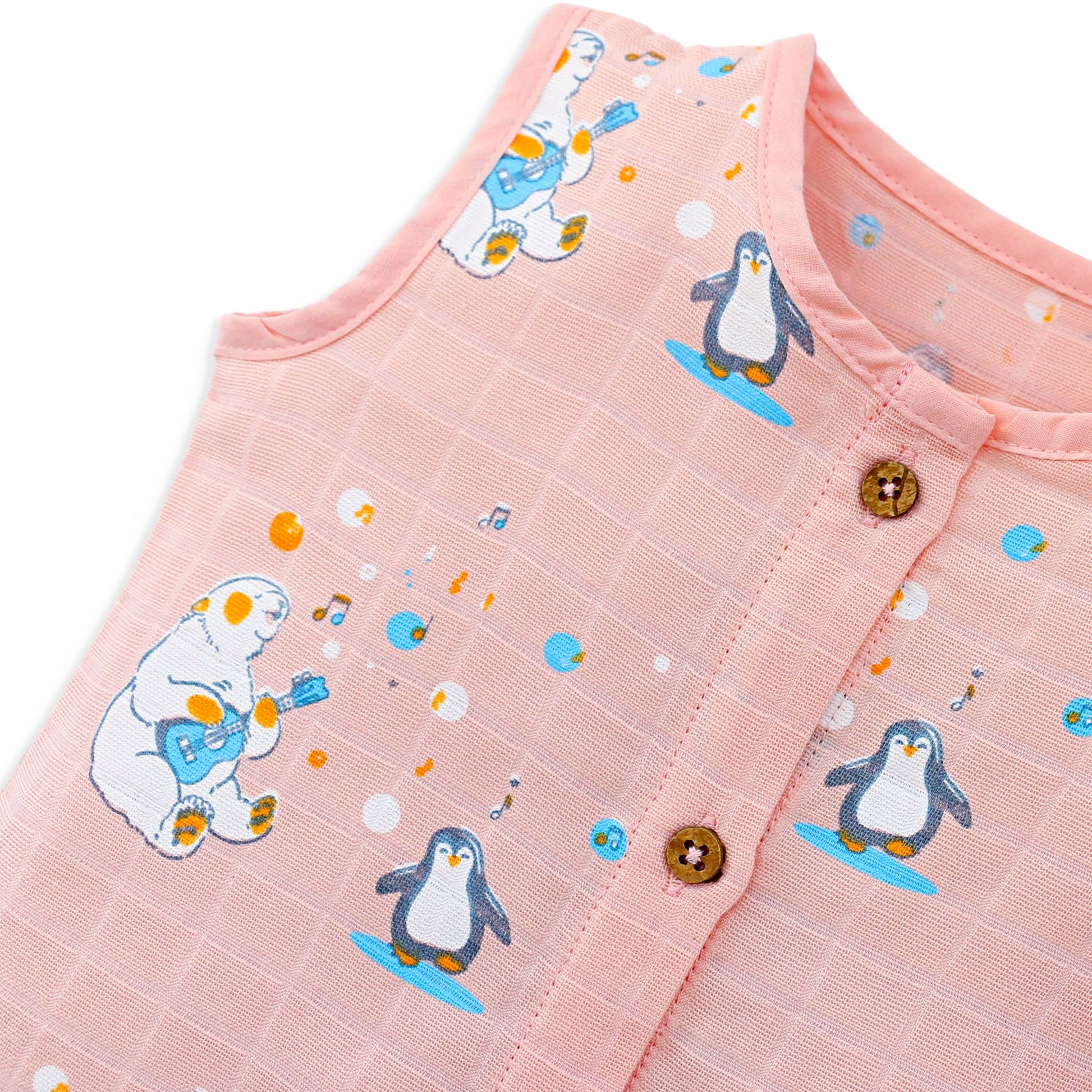 Muslin cotton baby top fabric close up with penguin print soft breathable texture detail